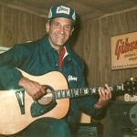 BILL GORDON IN GIBSON GEAR WITH ACCOUSTIC GIBSON IN HAND